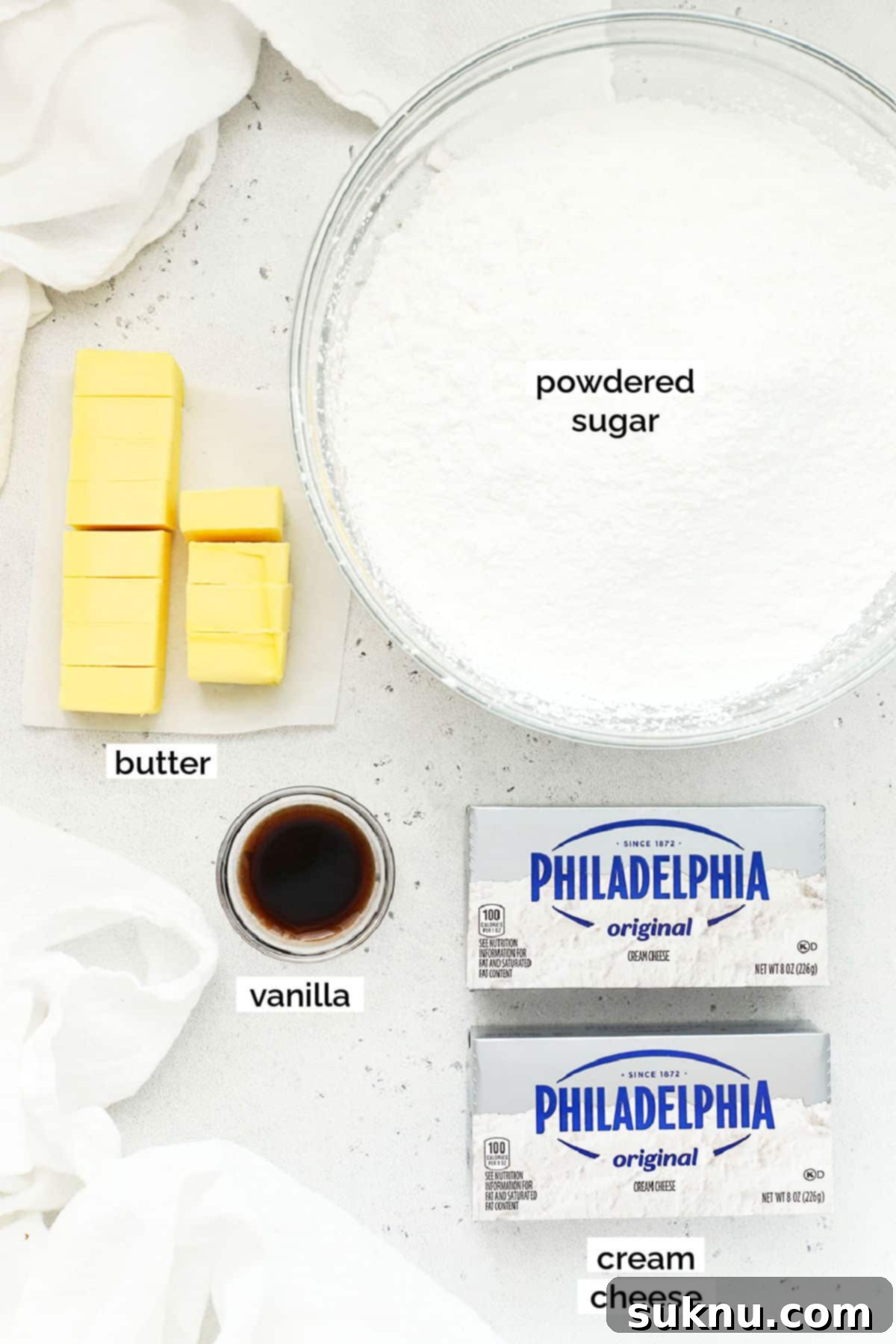 Essential ingredients laid out for making the best gluten-free cream cheese frosting.