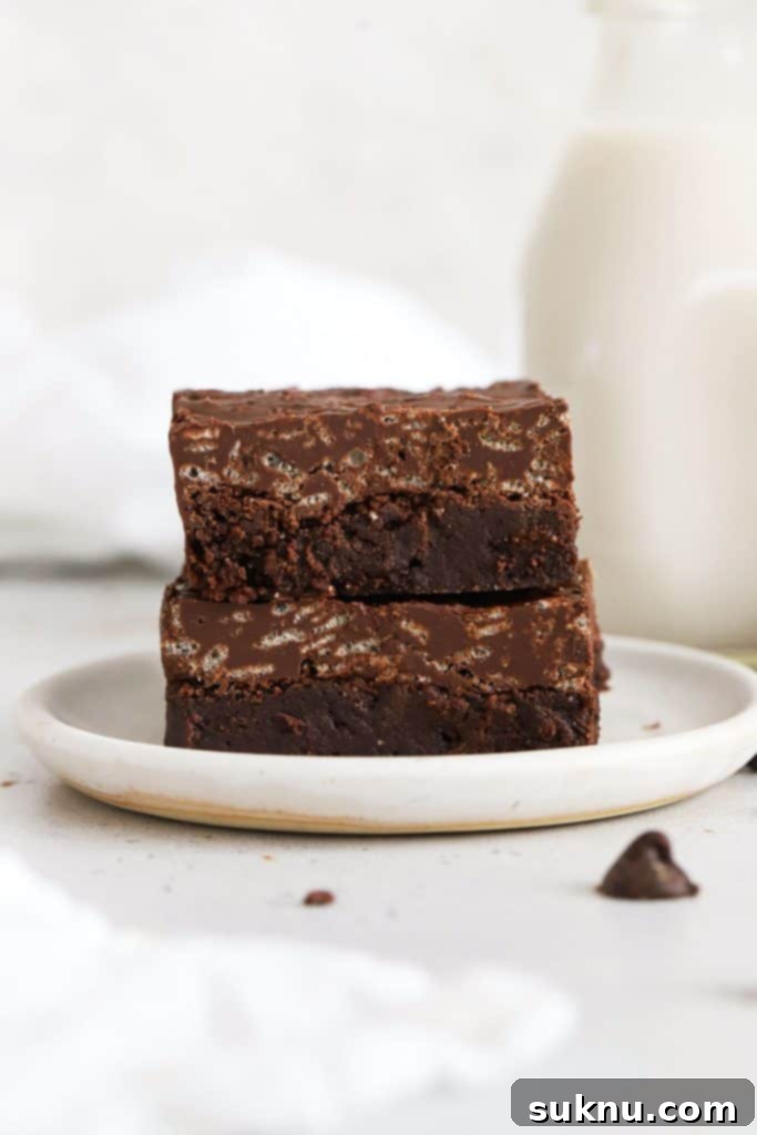 two gluten-free crunch brownies on a white plate