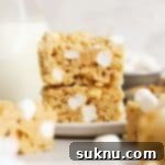 gluten-free peanut butter rice krispie treats stacked on a white plate
