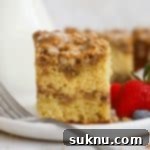 gluten-free cinnamon crumb cake on a white plate with fresh berries