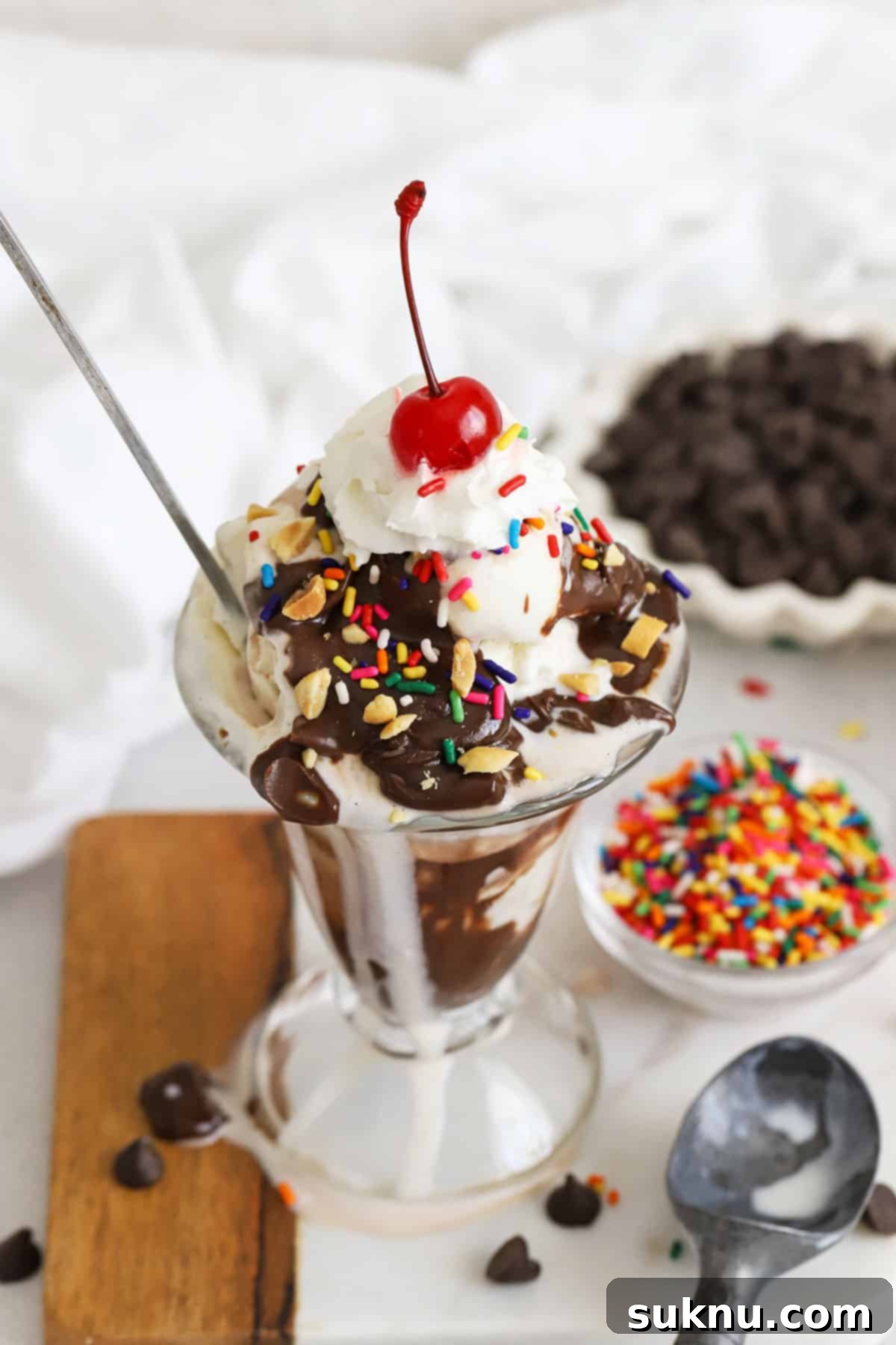 Decadent Hot Fudge Sundae 2 Classic ice cream sundae with homemade hot fudge sauce, whipped cream, sprinkles, nuts, and a maraschino cherry