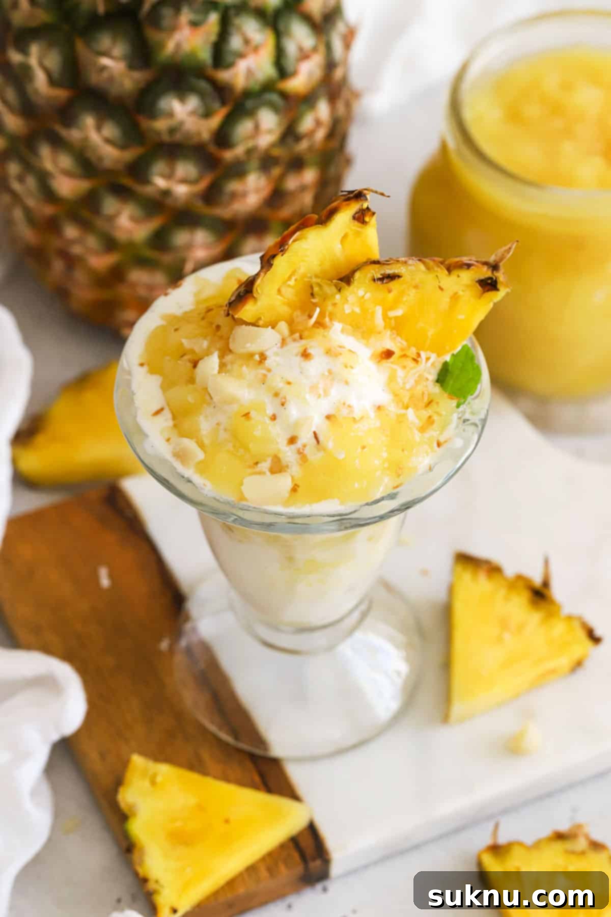Vanilla ice cream with homemade pineapple topping, toasted coconut, macadamia nuts, and fresh pineapple