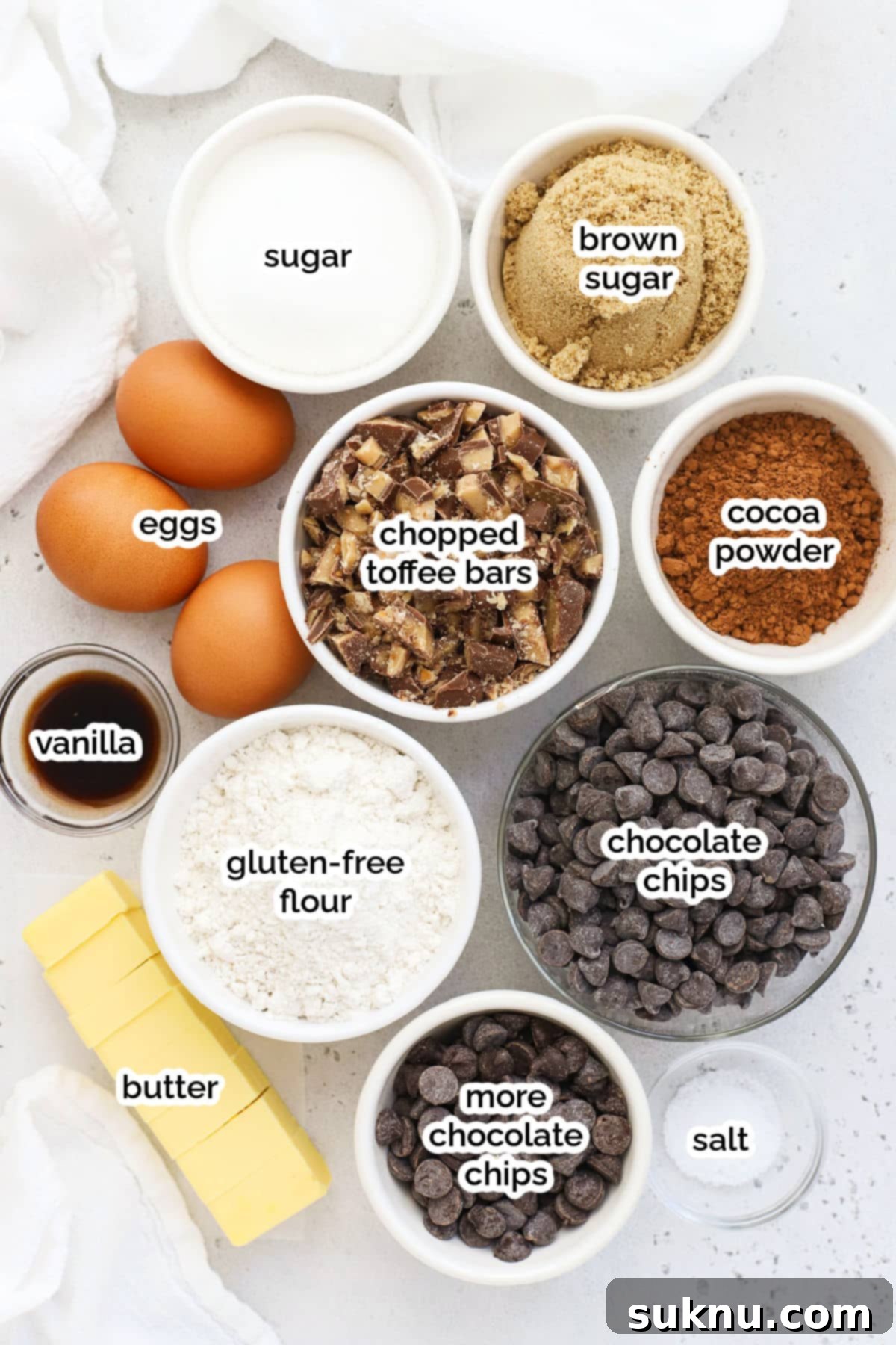 Decadent Gluten-Free Toffee Brownies 3 A collection of simple ingredients for gluten-free toffee brownies, including butter, chocolate chips, sugars, eggs, flour, and toffee bars.