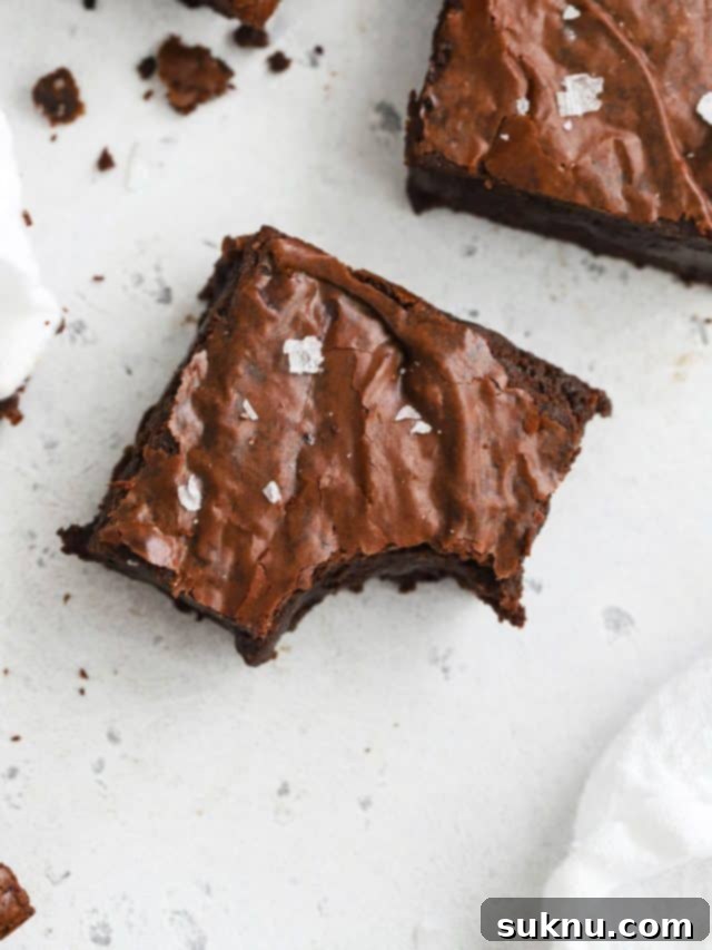 Decadent Gluten-Free Toffee Brownies 9 Close up overhead view of fudgy gluten-free brown butter brownies cut in squares, highlighting their rich texture.