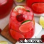 cherry limeade topped with fresh cherries and lime slices