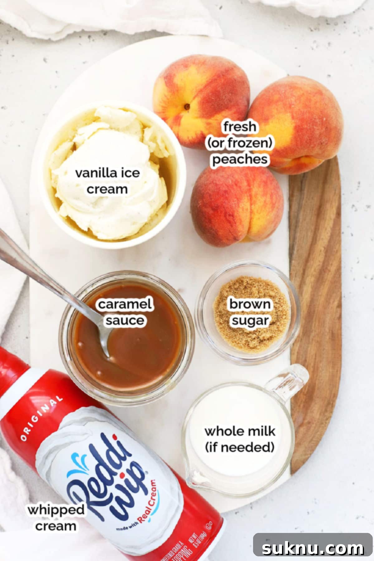 Peachy Dream Shake 3 Ingredients laid out for making peach milkshakes, including fresh peaches, vanilla ice cream, and milk.