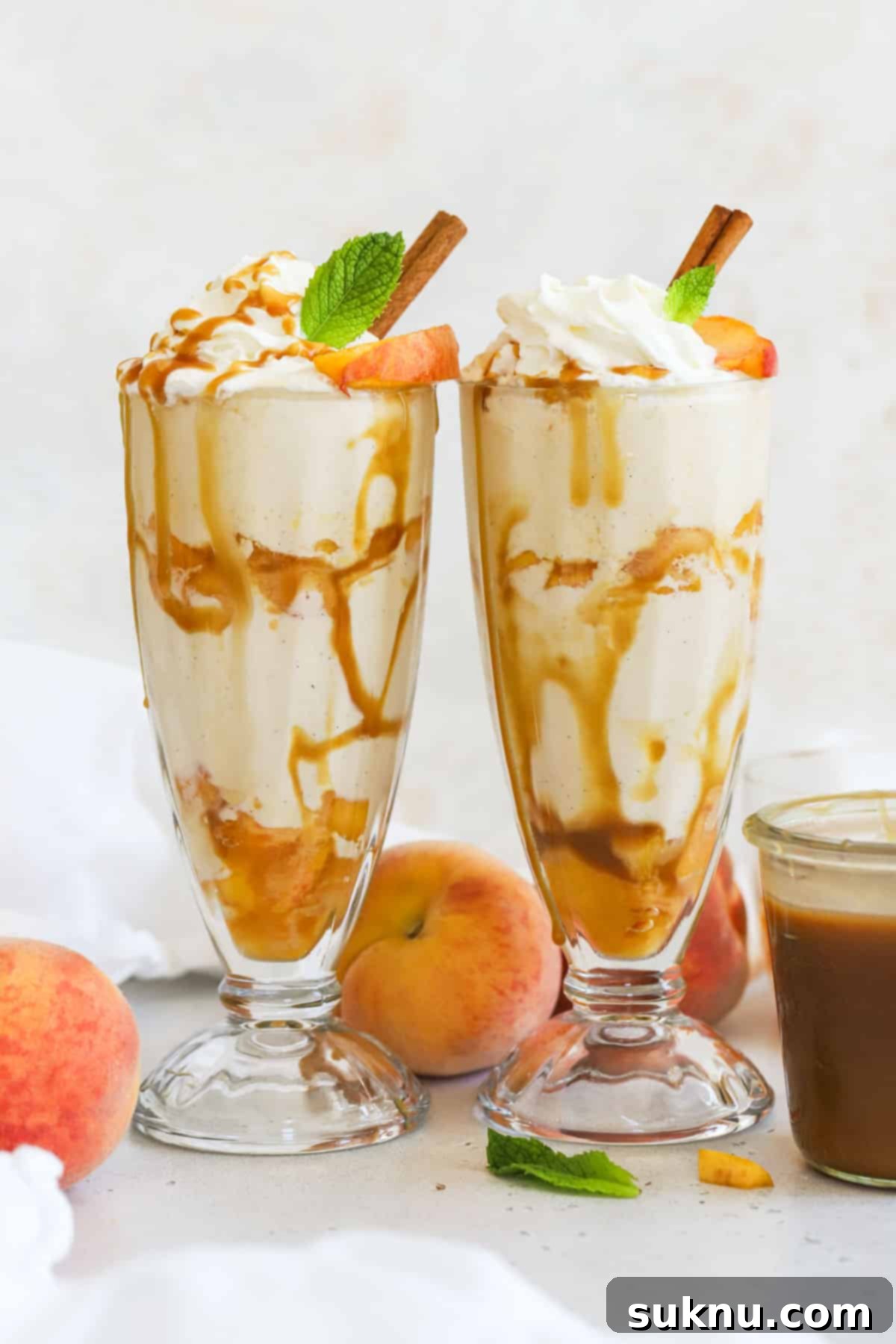 Peachy Dream Shake 6 Several homemade peach milkshakes with whipped cream, caramel sauce, and fresh peach garnishes, arranged beautifully.