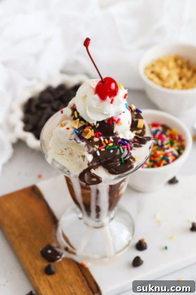 Peachy Dream Shake 7 Classic ice cream sundae with homemade hot fudge sauce, whipped cream, sprinkles, nuts, and a maraschino cherry.
