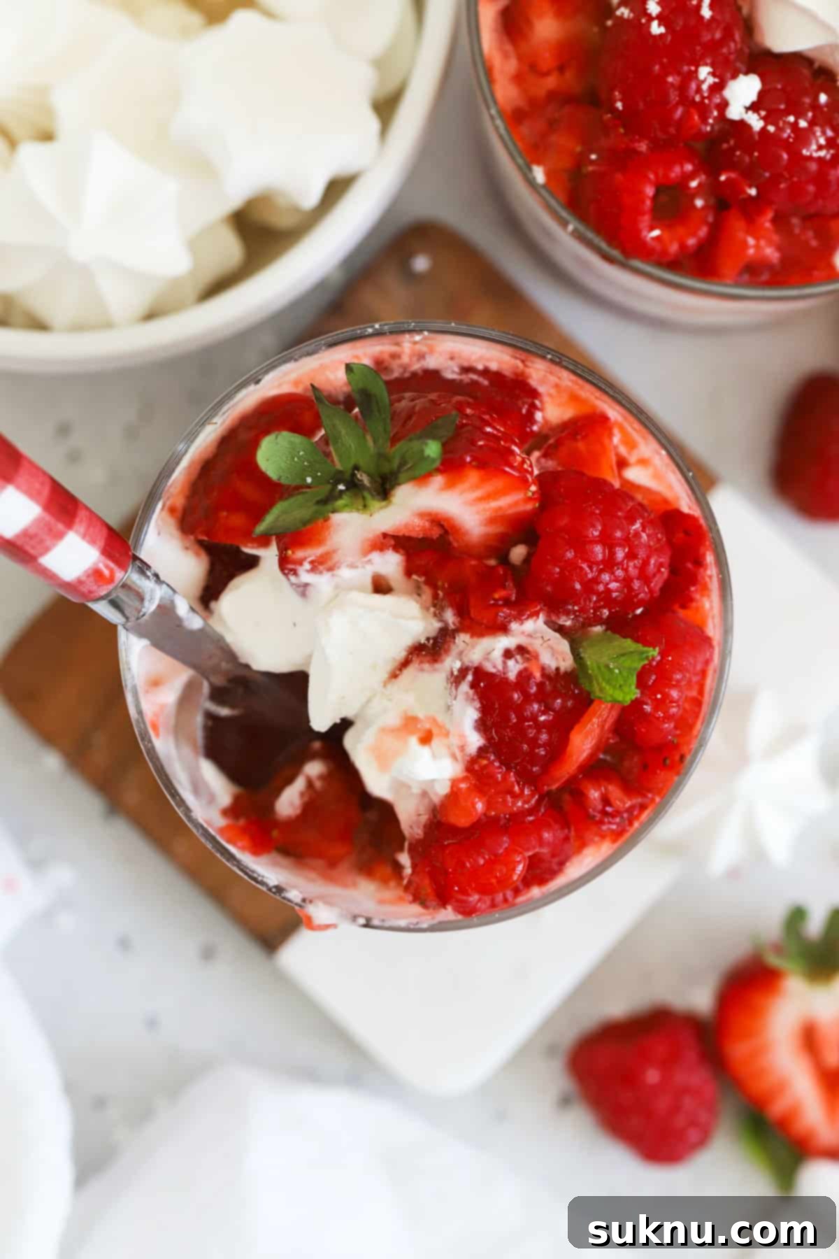 Red and white gingham spoon scooping a spoonful of Strawberry Eton Mess