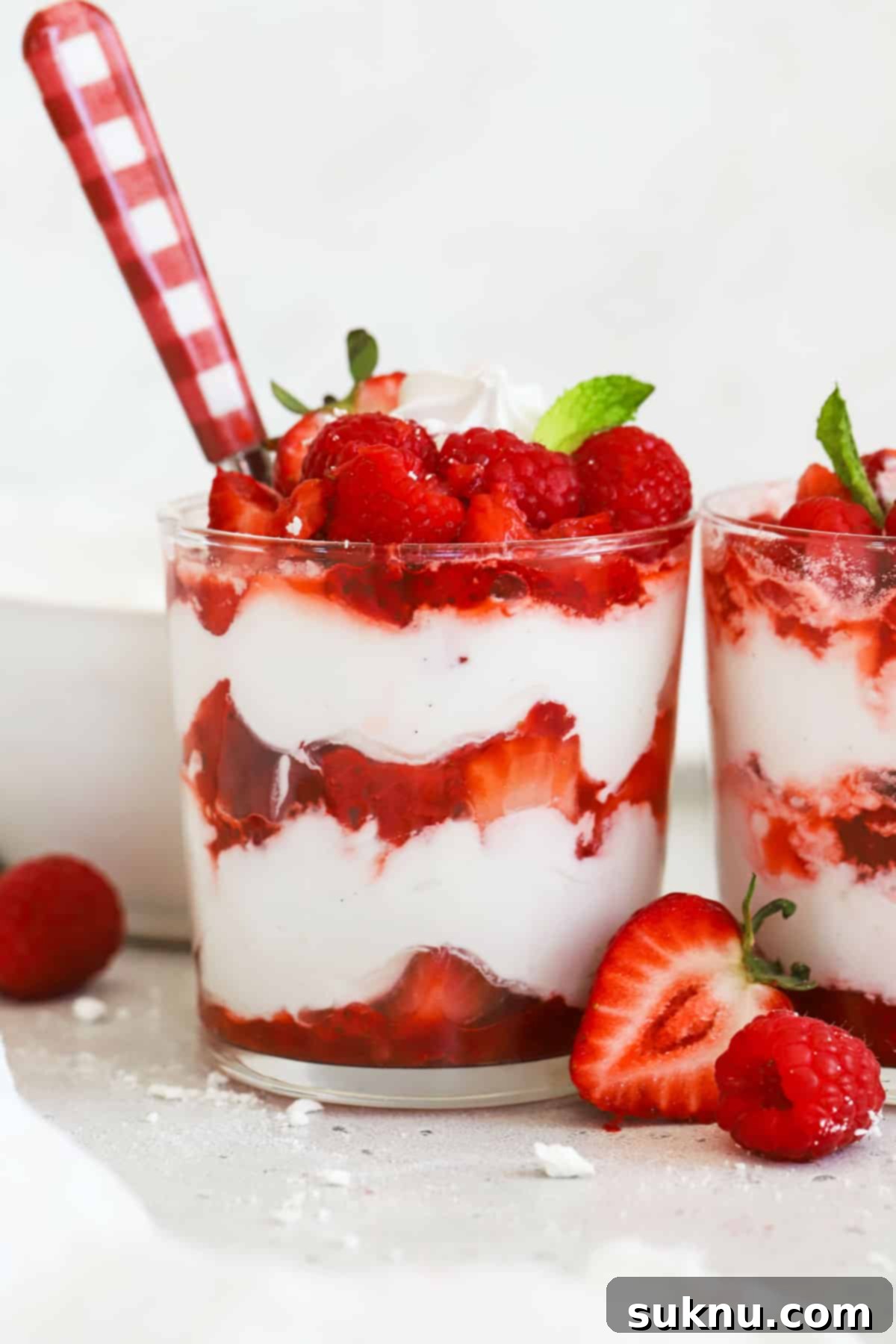 Small dishes of Strawberry Eton Mess with fresh mint garnish, ready to be served