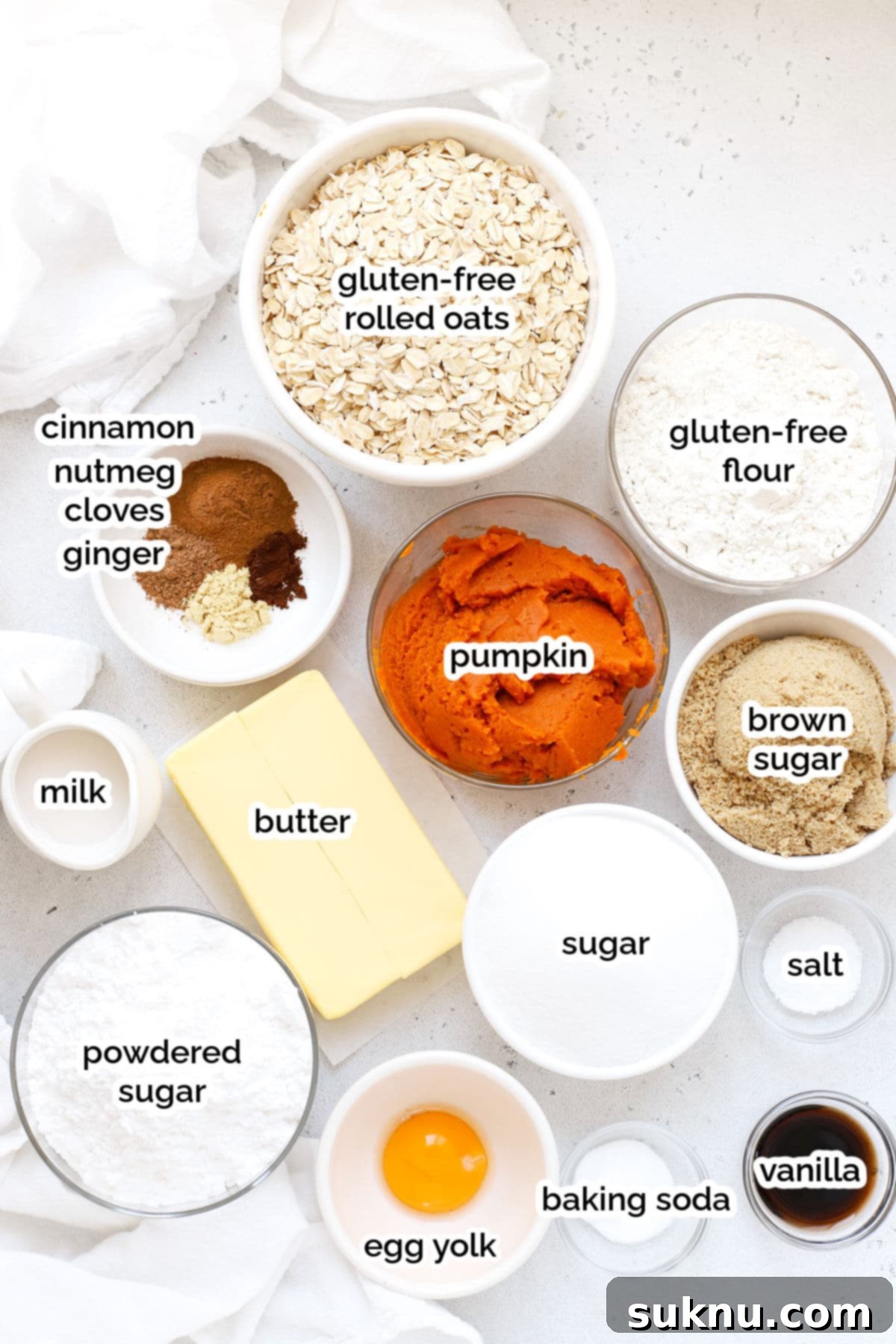 Autumn Spice Gluten-Free Pumpkin Oat Cookies 3 Array of fresh ingredients laid out for making gluten-free pumpkin oatmeal cookies, including pumpkin puree, spices, butter, and gluten-free flour.