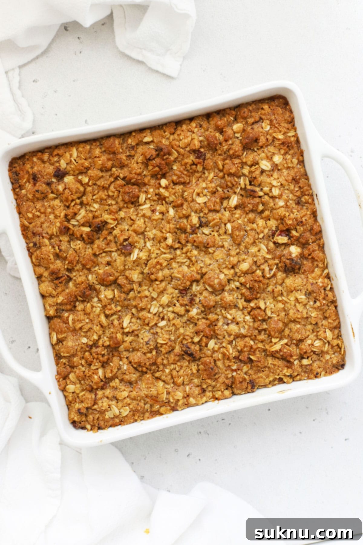 Cozy Gluten-Free Pumpkin Crisp 5 A baking pan filled with warm gluten-free pumpkin crisp, featuring a delicious oat crumble topping, fresh from the oven.