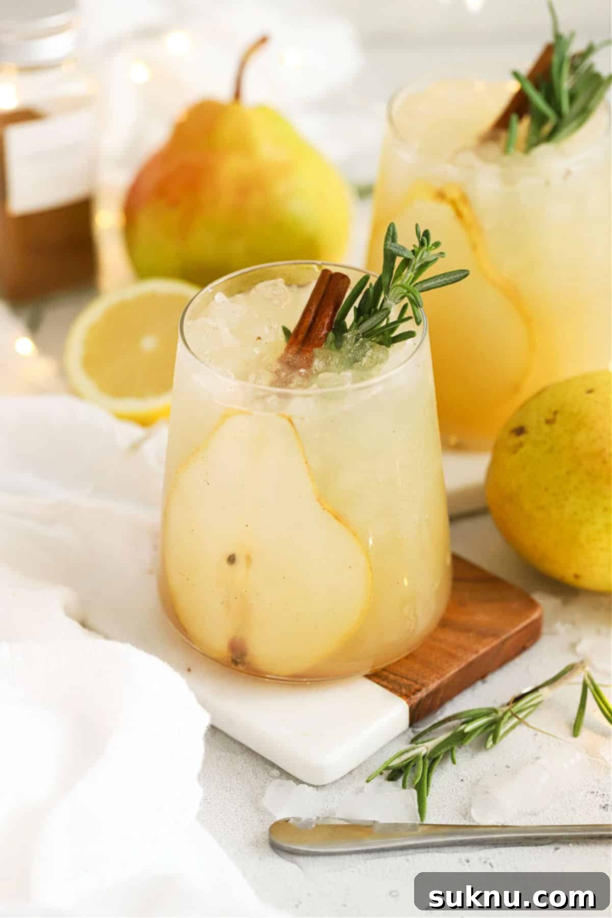 Crisp Pear Ginger Fizz 2 Fresh pear punch with slices of pear, cinnamon sticks, and fresh rosemary