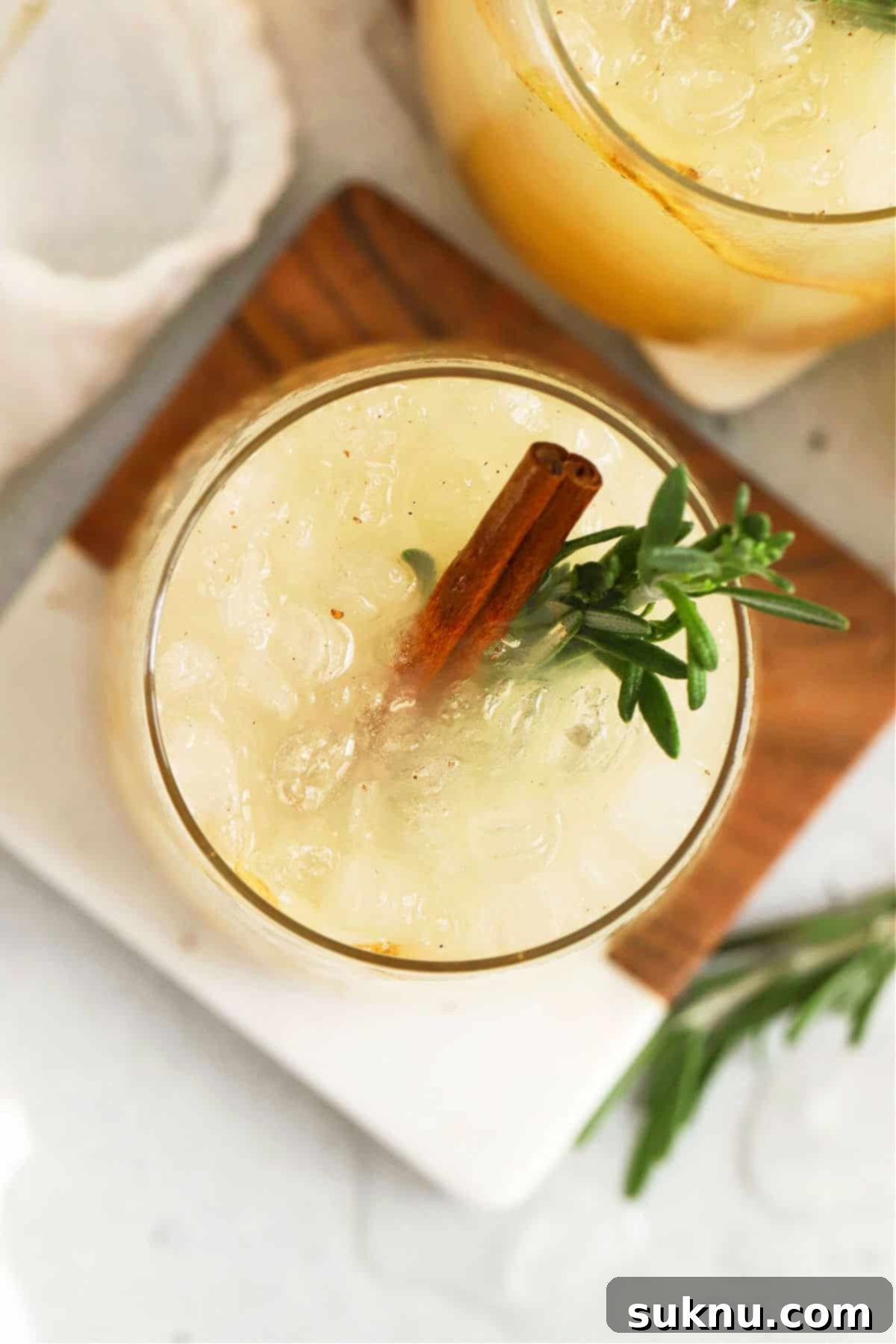 Crisp Pear Ginger Fizz 5 Pear mocktail garnished with rosemary and a cinnamon stick