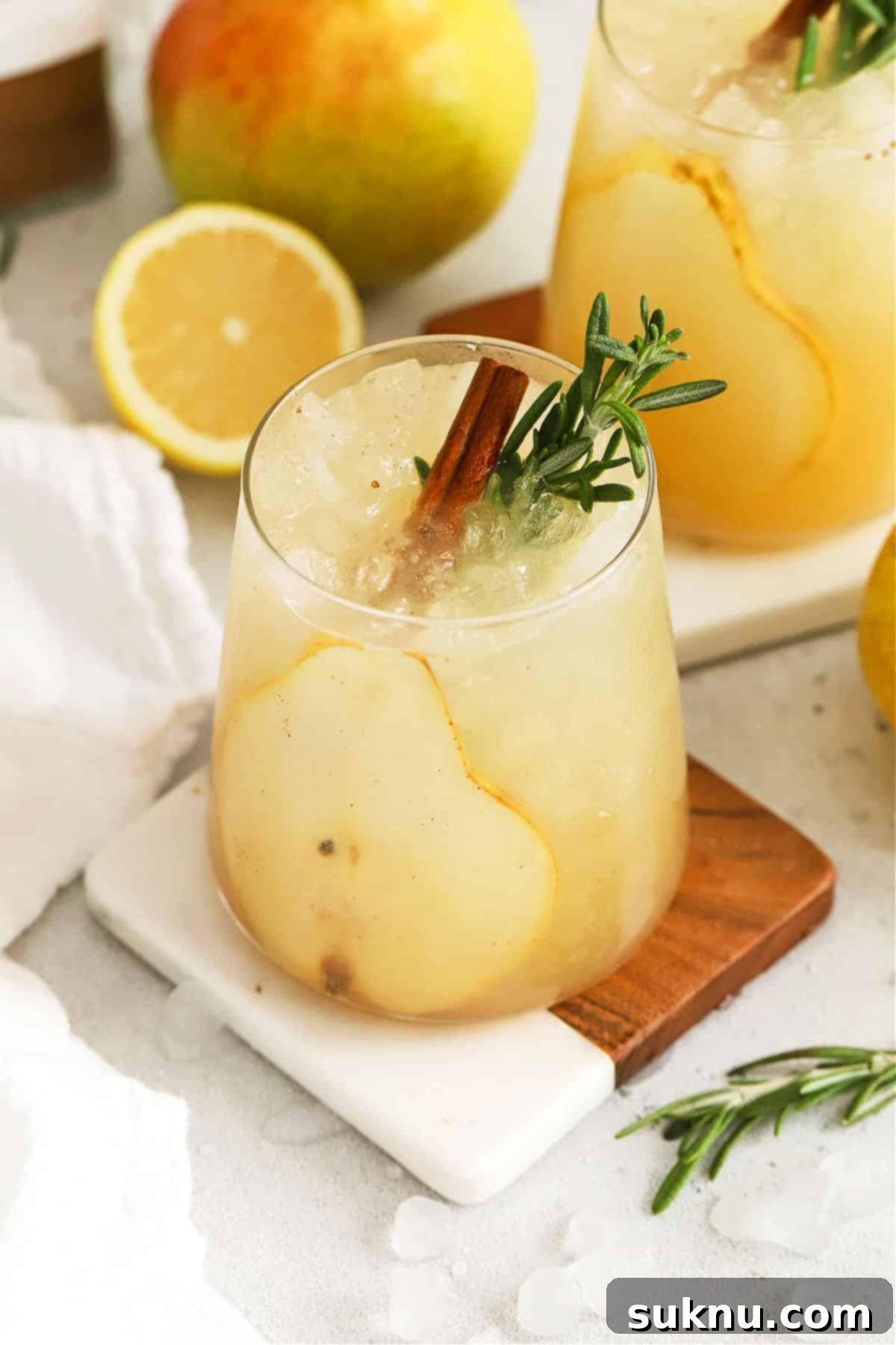 Crisp Pear Ginger Fizz 7 Fresh pear punch with slices of pear, cinnamon sticks, and fresh rosemary