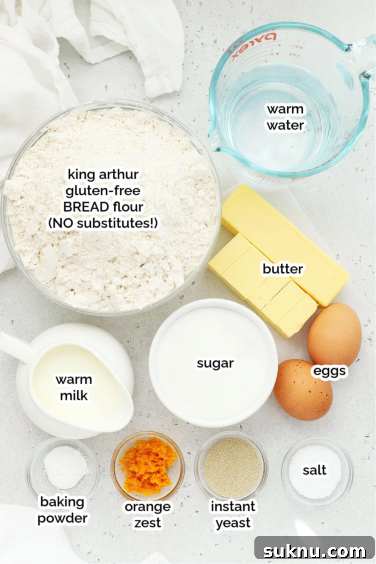 Ingredients for making gluten-free orange rolls laid out on a kitchen counter.