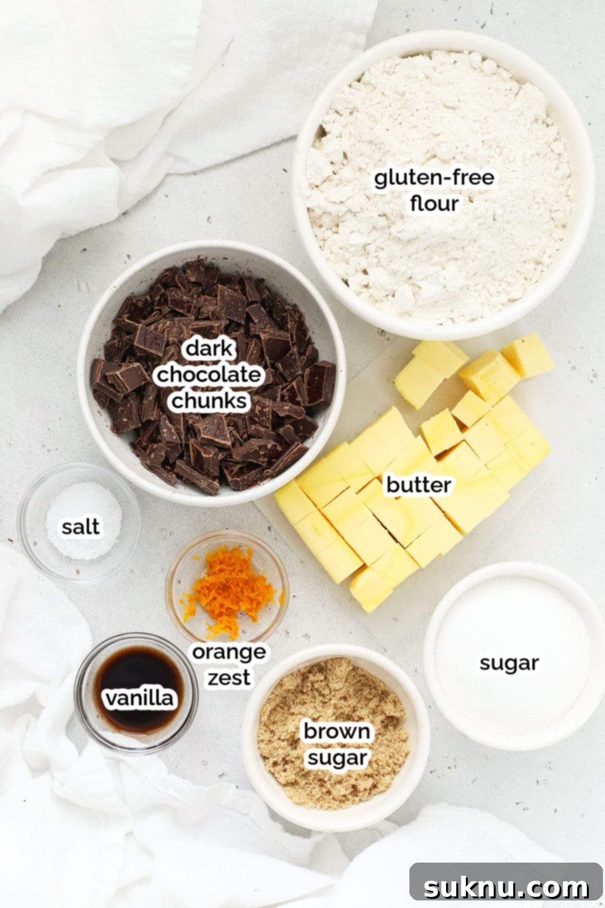 Wholesome Gluten-Free Orange Chocolate Buttery Bites 3 Ingredients for Gluten-Free Orange Chocolate Chunk Shortbread Cookies laid out on a surface.