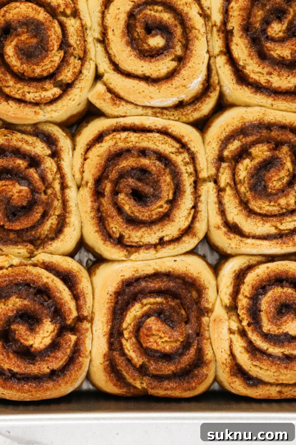 Warm gluten-free cinnamon rolls, unfrosted and ready for topping