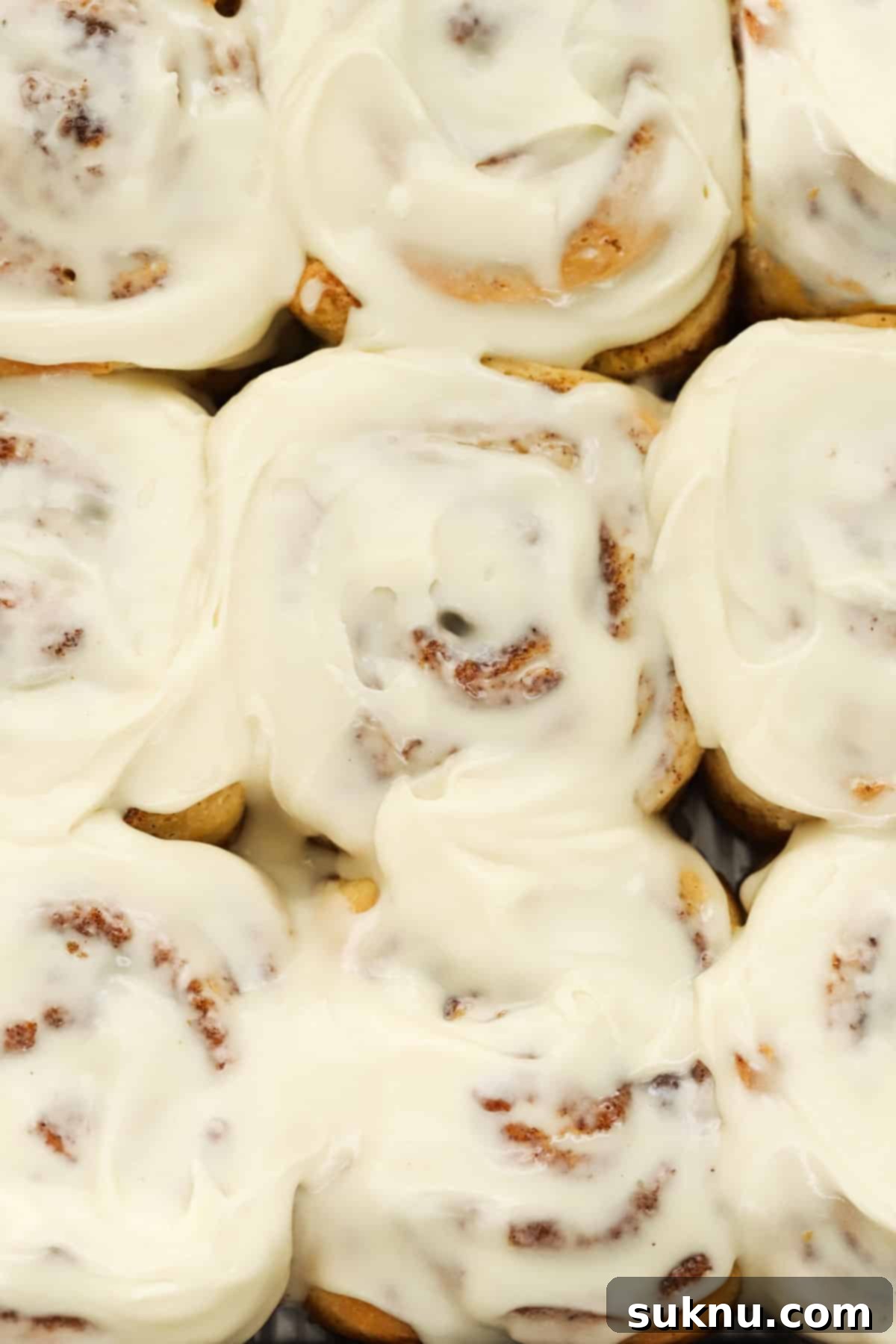 Gluten-free cinnamon rolls with cream cheese frosting, in a baking pan