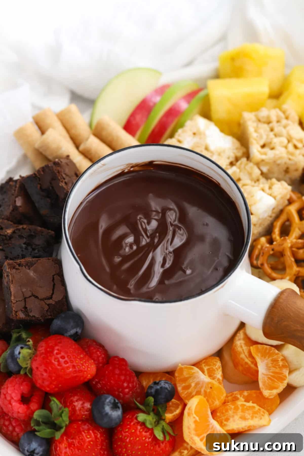 Close-up of glossy chocolate fondue ready for dipping, presented on a elegant dessert platter.