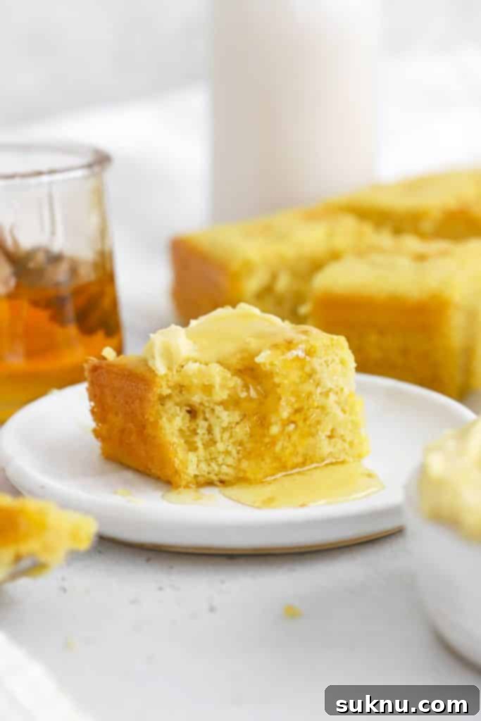 Gluten-free cornbread being drizzled with honey