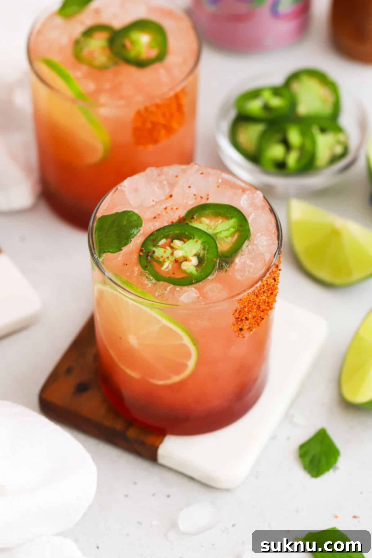 Close-up of a guava mocktail with jalapeño and lime garnishes