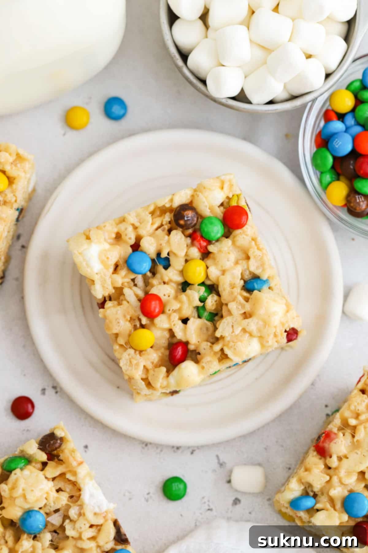 Gluten-Free M and M Rice Krispies Treats 2 Gluten-Free M&M Rice Krispie Treats cut into perfect squares, showcasing colorful mini M&M candies throughout.