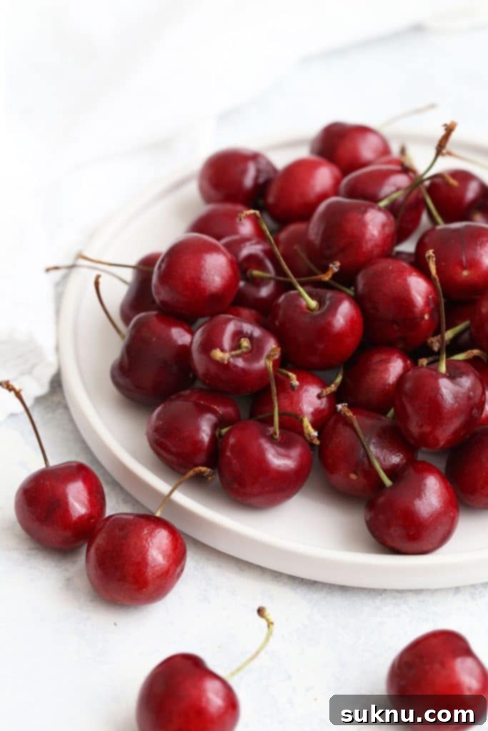 Luscious Gluten-Free Cherry Crisp 5 fresh cherries on a white plate