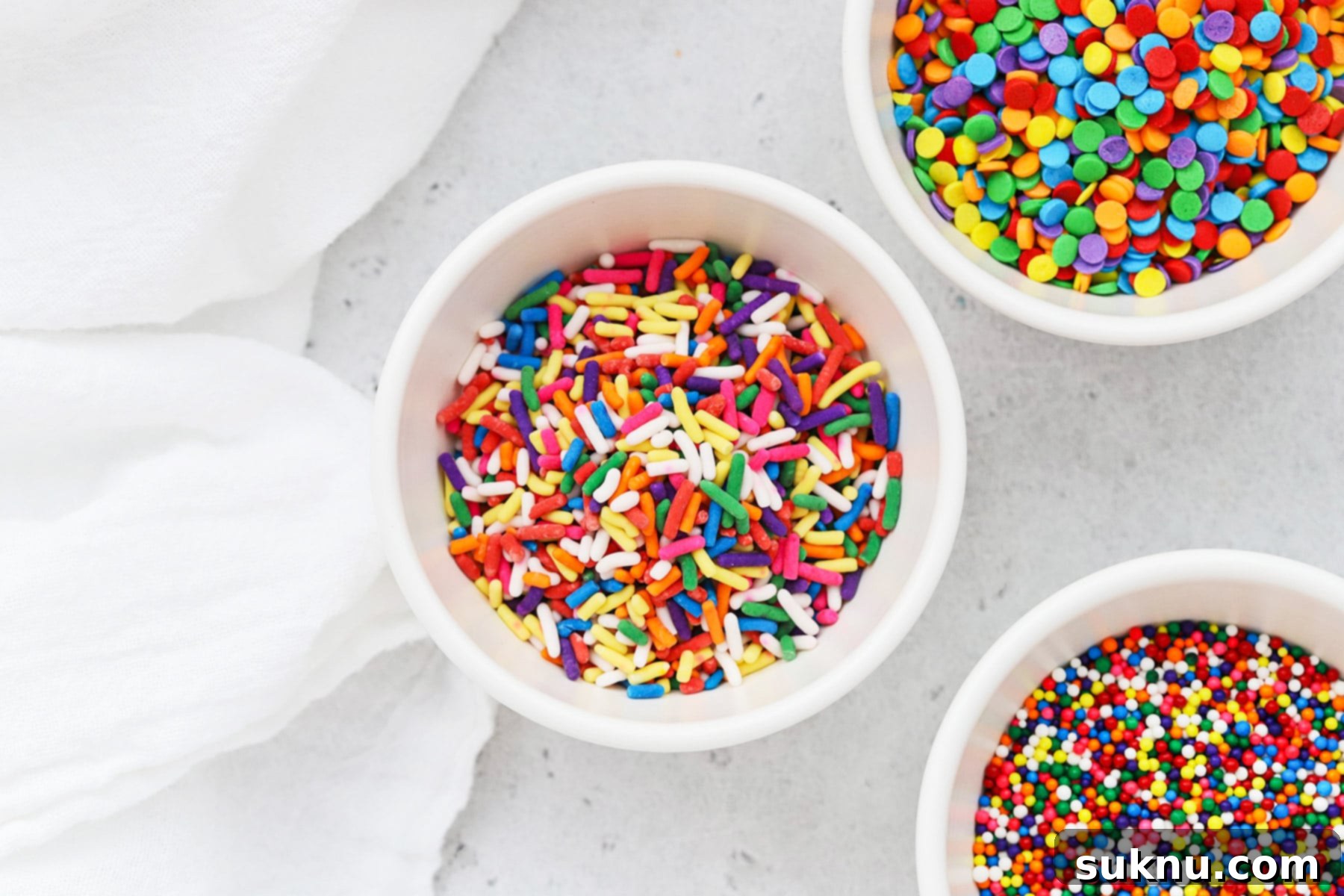 Bowls filled with different kinds of colorful sprinkles, ready for decorating egg-free, gluten-free desserts.