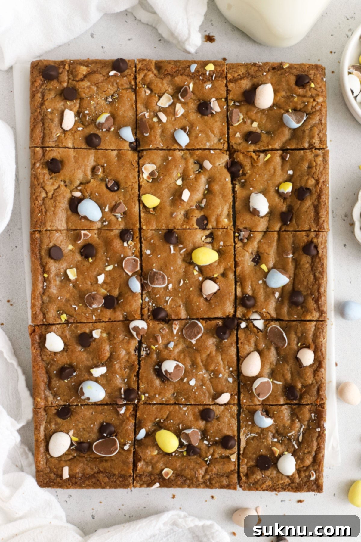 Decadent Gluten-Free Cadbury Blondies 2 Delicious gluten-free Cadbury blondies cut into perfect squares, adorned with colorful mini egg pieces, ready for serving at an Easter gathering.