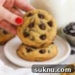 gluten-free pudding mix chocolate chip cookies stacked next to a bottle of milk