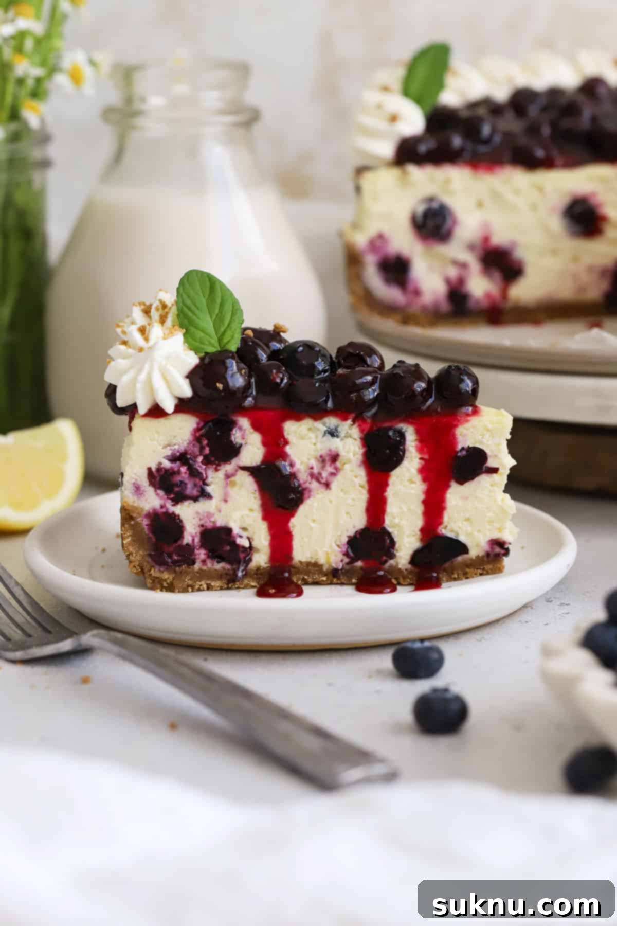 Easy Blueberry Sauce For Cheesecake And Beyond 5 Exquisitely presented slices of gluten-free blueberry cheesecake, lavishly topped with fresh blueberry sauce and a delicate swirl of whipped cream.