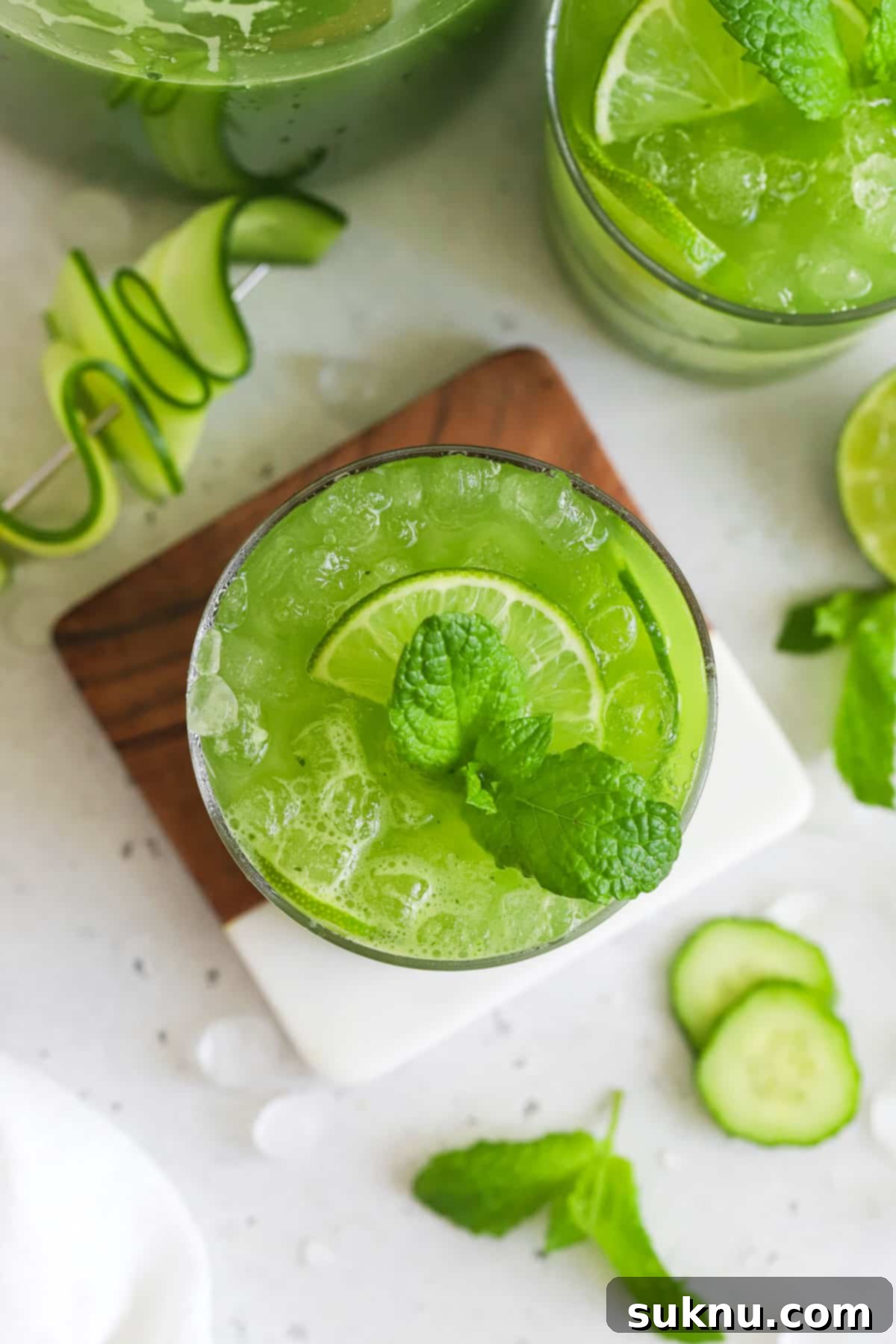 Crisp Cucumber Refreshment 5 Cucumber Cooler Mocktail garnished with fresh mint and lime slices