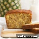 A whole loaf of gluten-free banana bread with pineapple and coconut, fresh out of the oven.