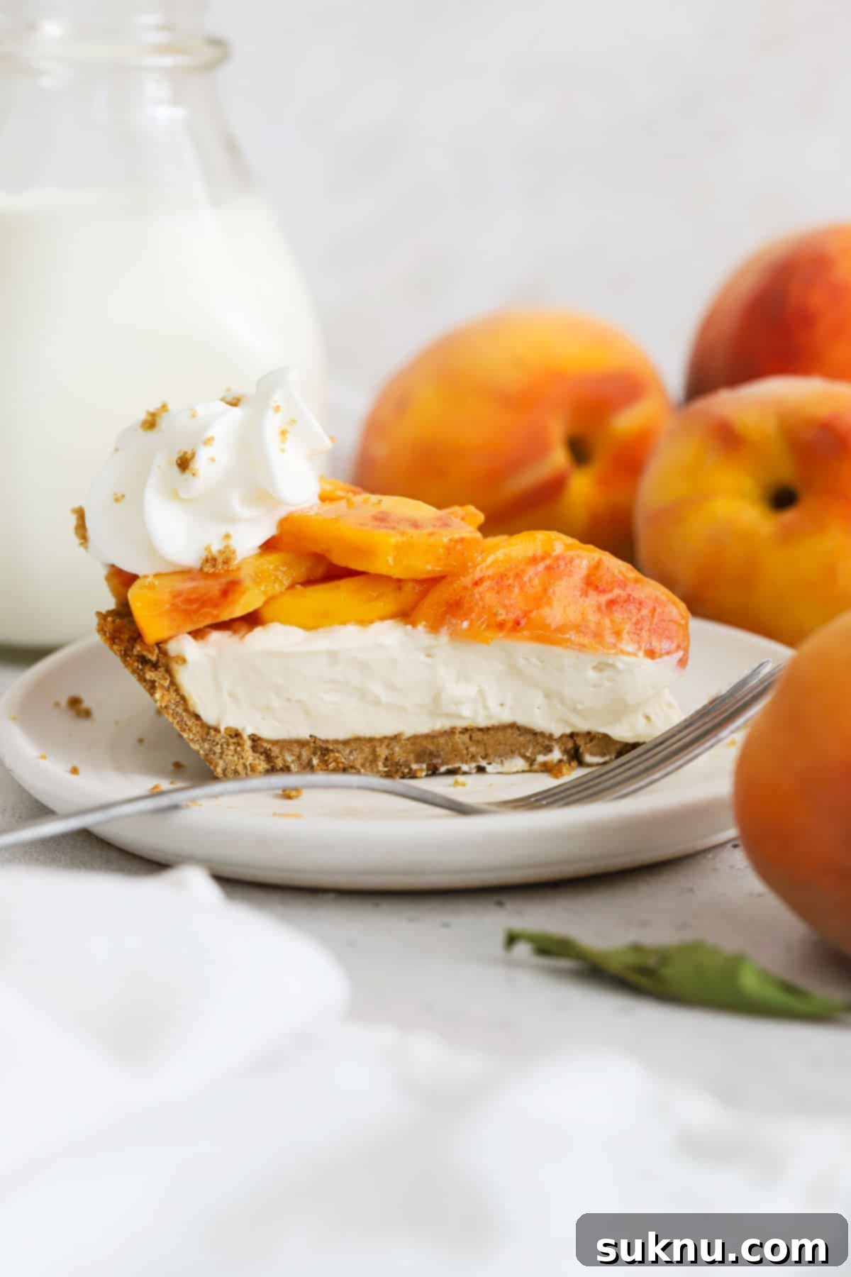 a slice of gluten-free peaches and cream pie on a white dessert plate