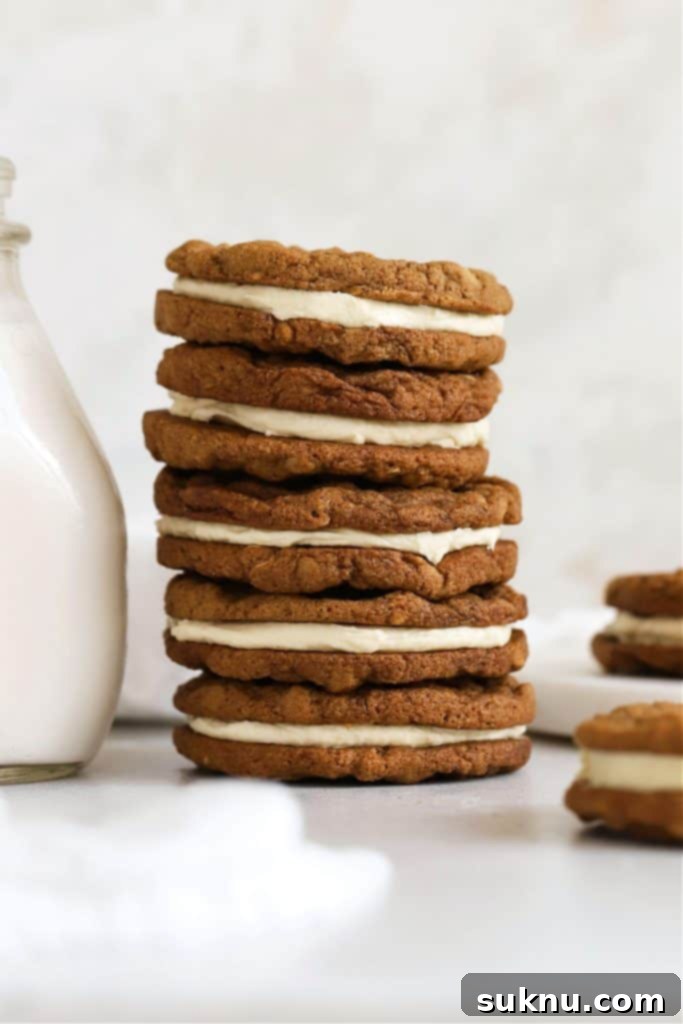 gluten-free oatmeal cream pies stacked next to a bottle of milk