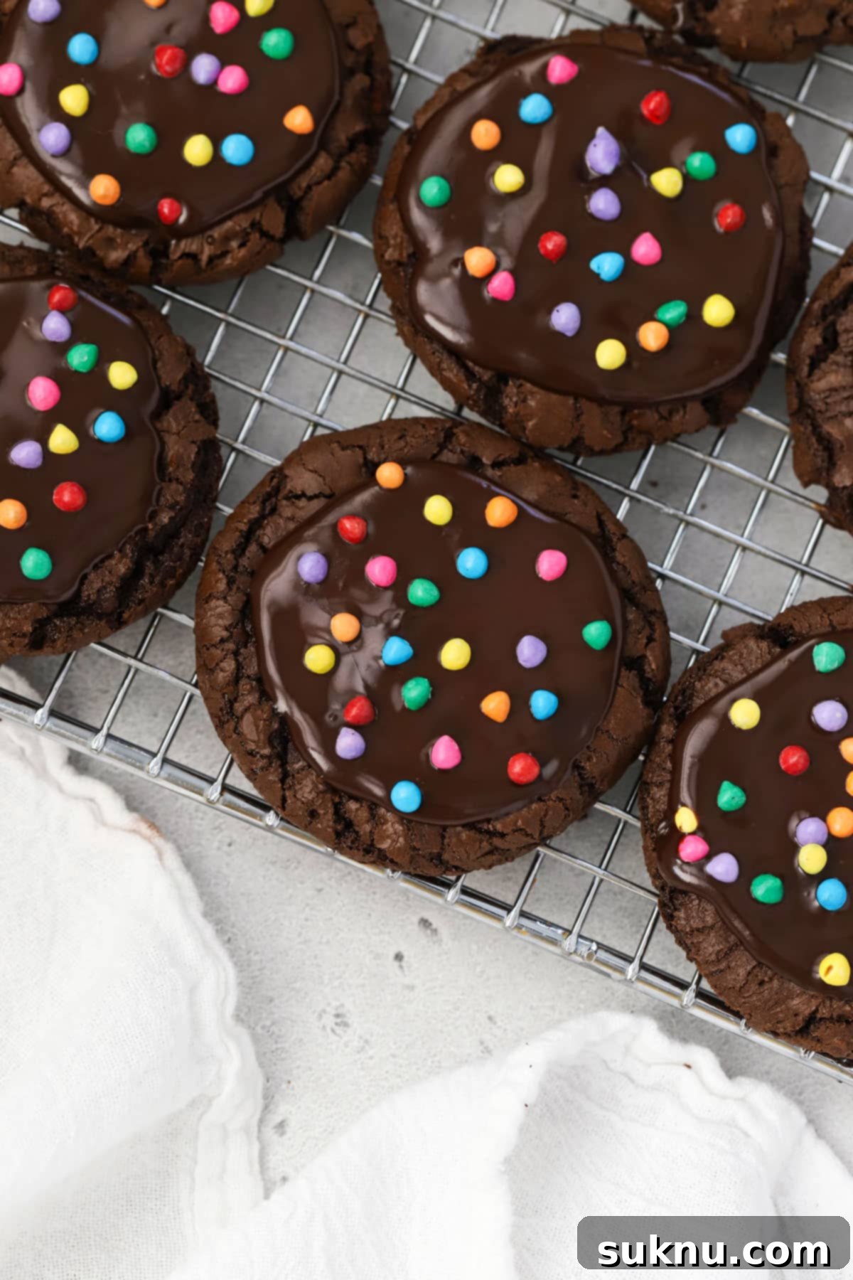 Gluten-free cosmic brownie cookies with chocolate ganache and rainbow bit sprinkles, ready to eat