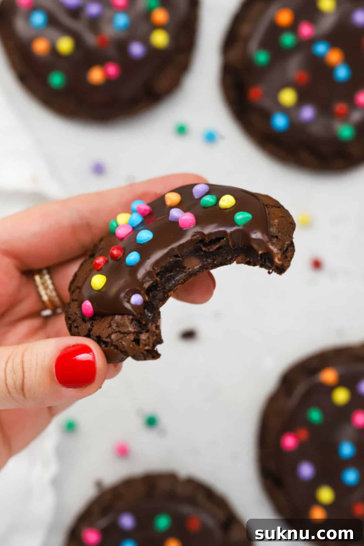 a gluten-free cosmic brownie cookie with a bite taken out of it, revealing a fudgy center and shiny top