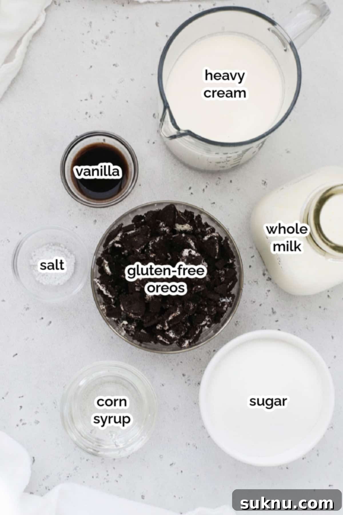Ingredients laid out for gluten-free cookies & cream ice cream, including heavy cream, milk, sugar, and gluten-free Oreos