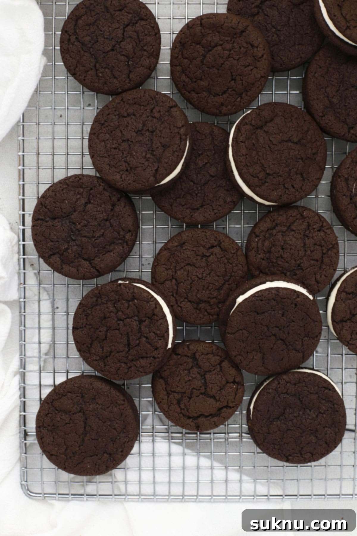 Homemade gluten-free Oreo cookies cooling on a wire rack after baking
