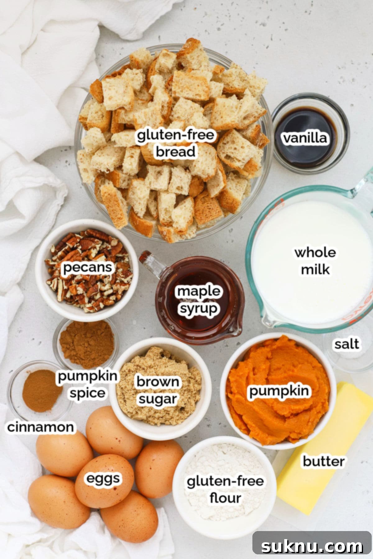 Gluten-Free Pumpkin Spice French Toast Casserole 4 Assortment of ingredients for gluten-free pumpkin french toast casserole, including bread, pumpkin puree, milk, eggs, and spices