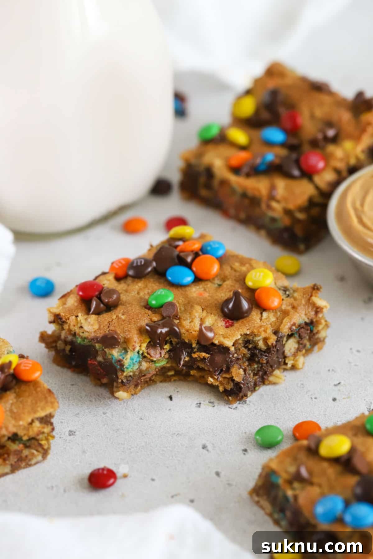 Gluten-Free Kitchen Sink Cookie Bars 9 A gluten-free monster cookie bar with a bite taken out of it