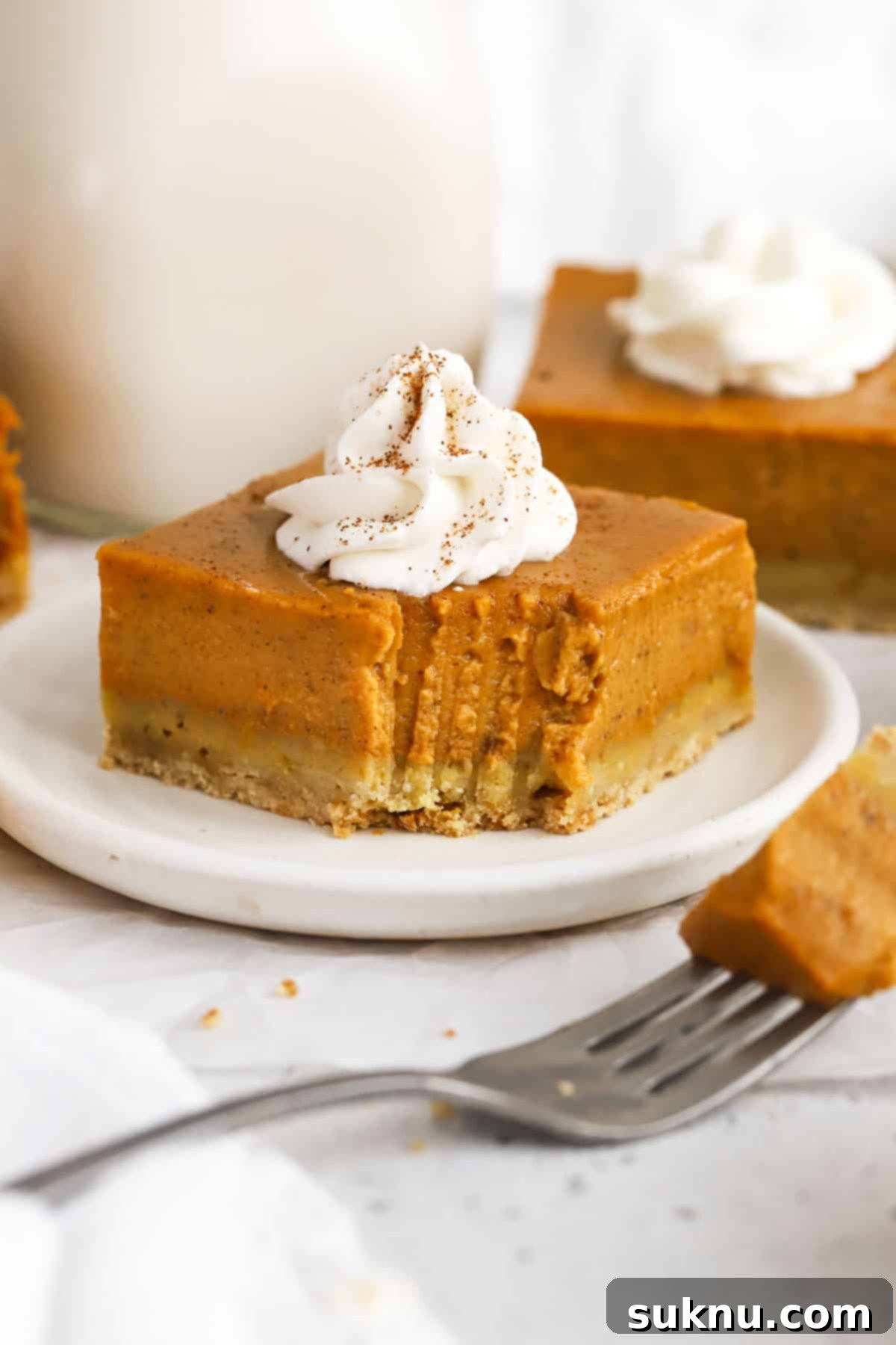 Gluten-free pumpkin pie bar with a bite taken out of it