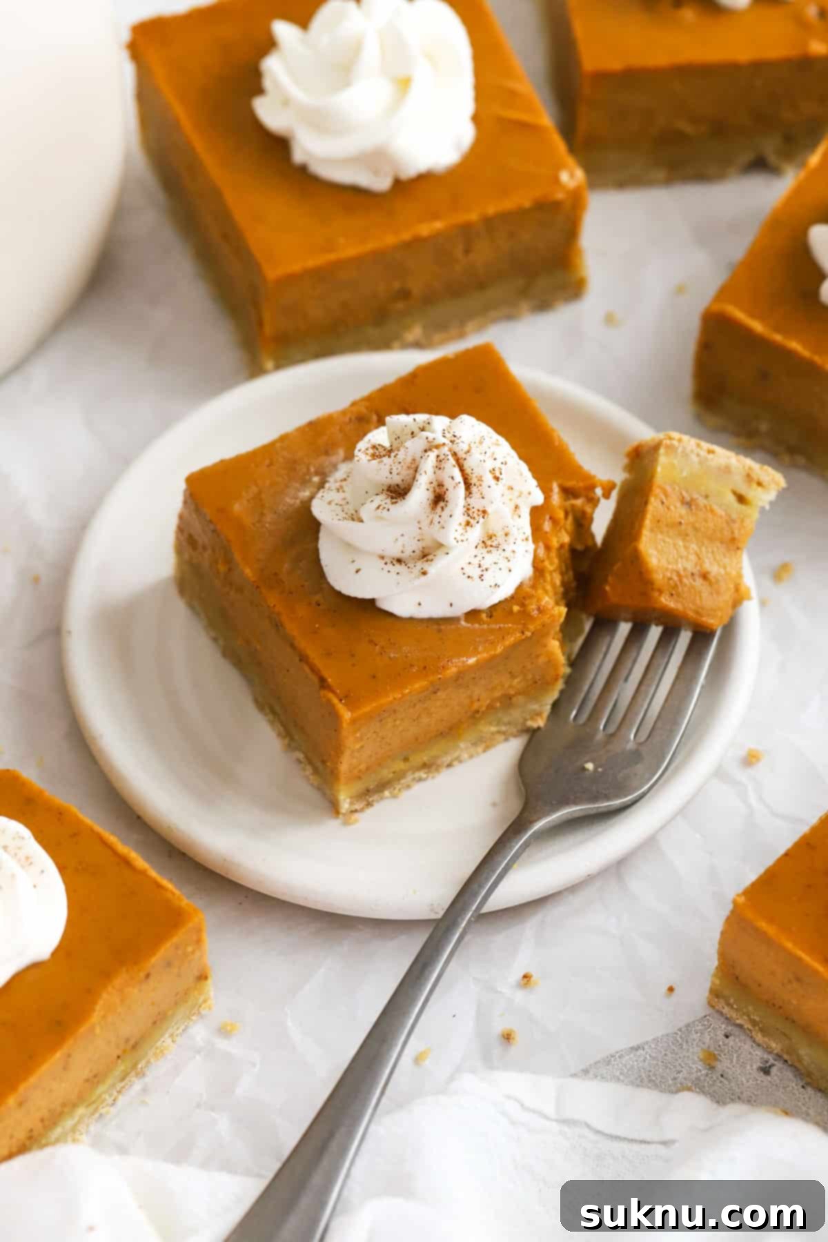A fork taking a bit out of a gluten-free pumpkin pie bar