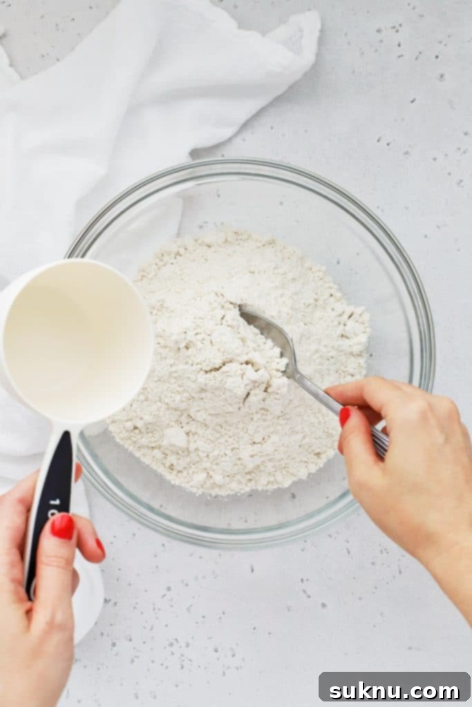Master Flour Measurement For Perfect Baking 3 Detailed overhead view of flour being loosened in a container