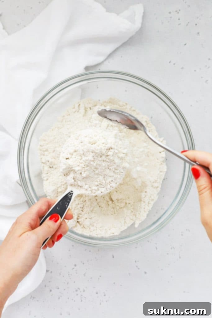 Master Flour Measurement For Perfect Baking 5 Flour filled in a measuring cup, slightly mounded, ready for leveling
