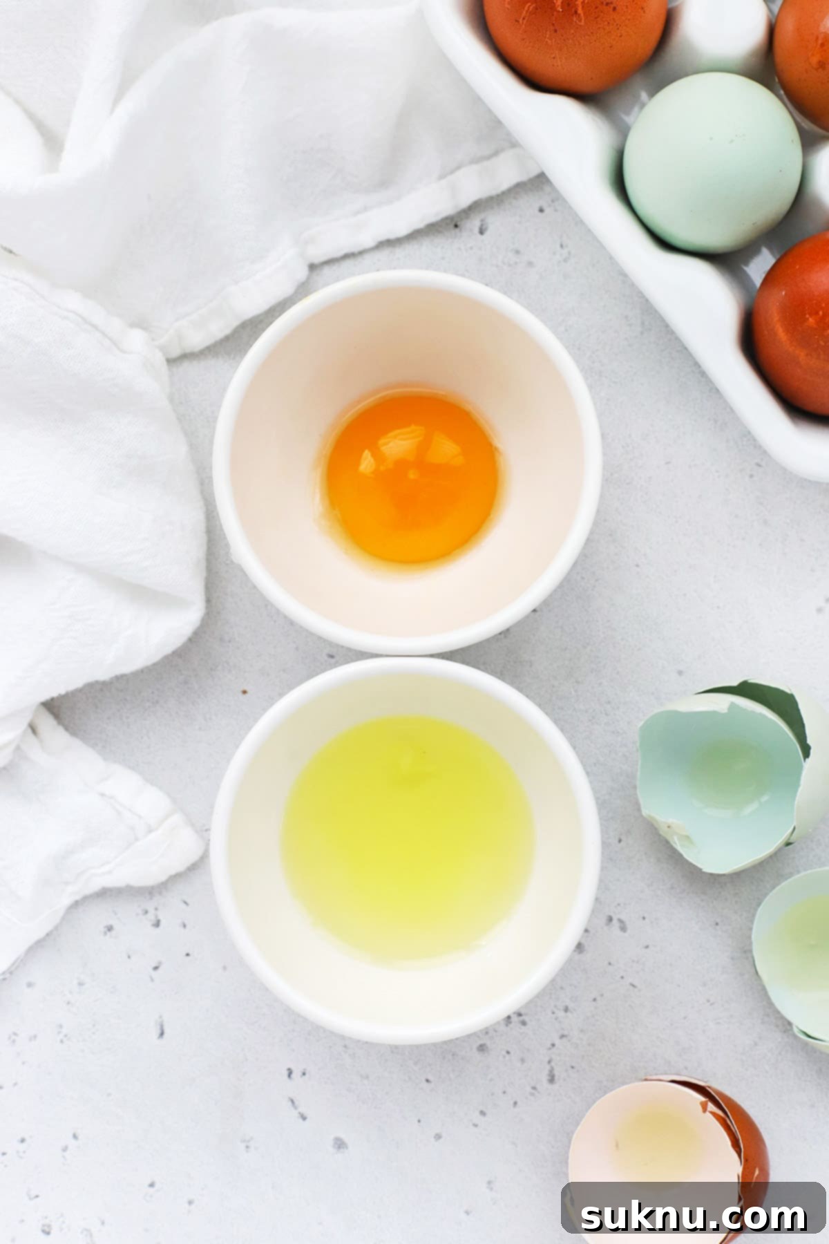 How to Separate Egg Whites and Yolks 3 Overhead view of perfectly separated egg, with the golden yolk in one bowl and the clear white in another bowl
