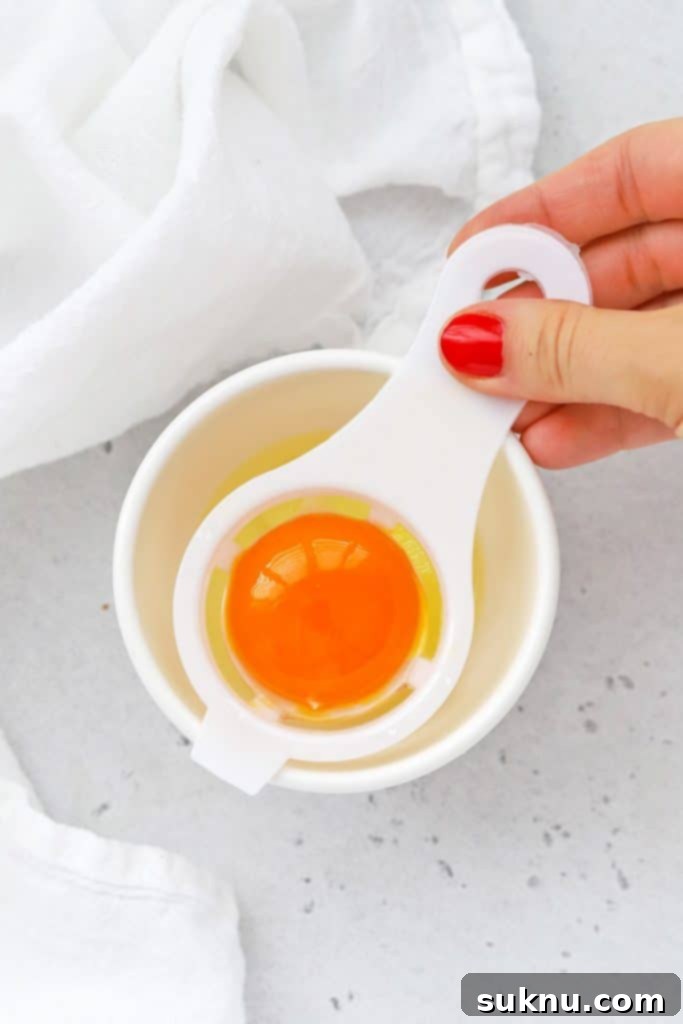 How to Separate Egg Whites and Yolks 4 Overhead view illustrating the use of an egg separator to easily divide egg yolks from egg whites