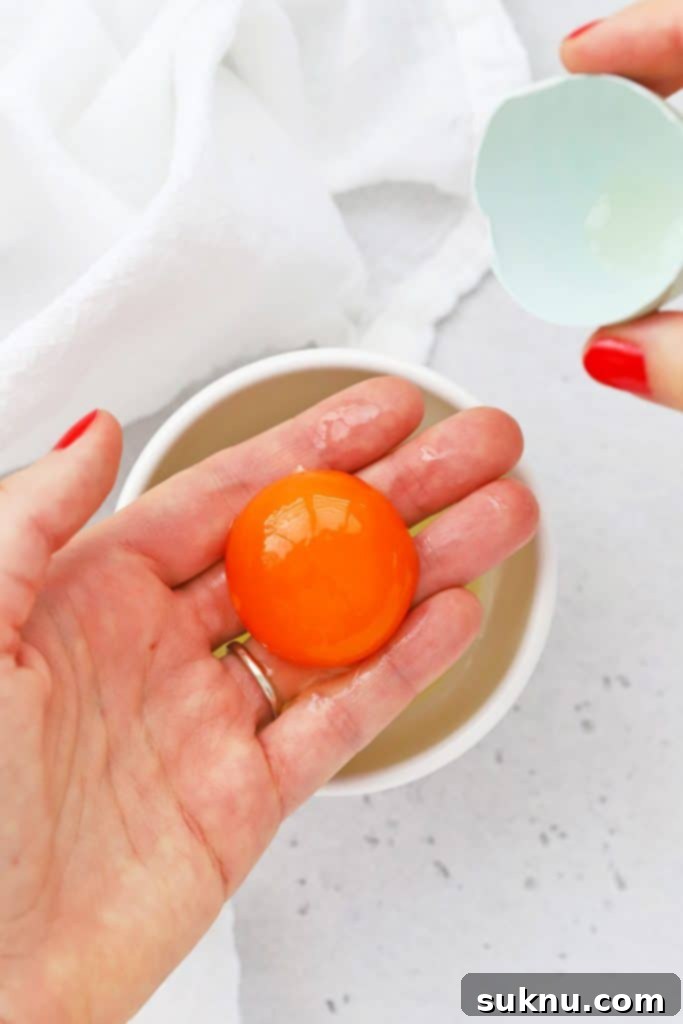 How to Separate Egg Whites and Yolks 5 Overhead view demonstrating how to separate egg yolks and egg whites using your clean hands