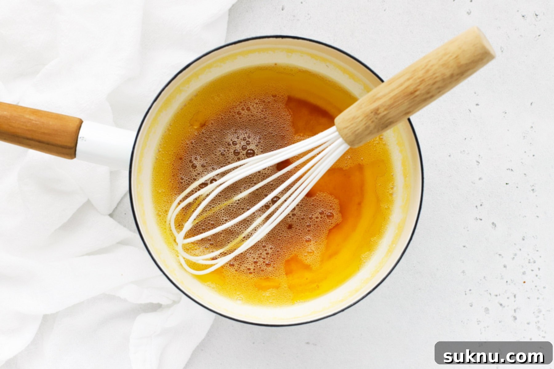 Close up overhead view of browned butter in a white saucepan